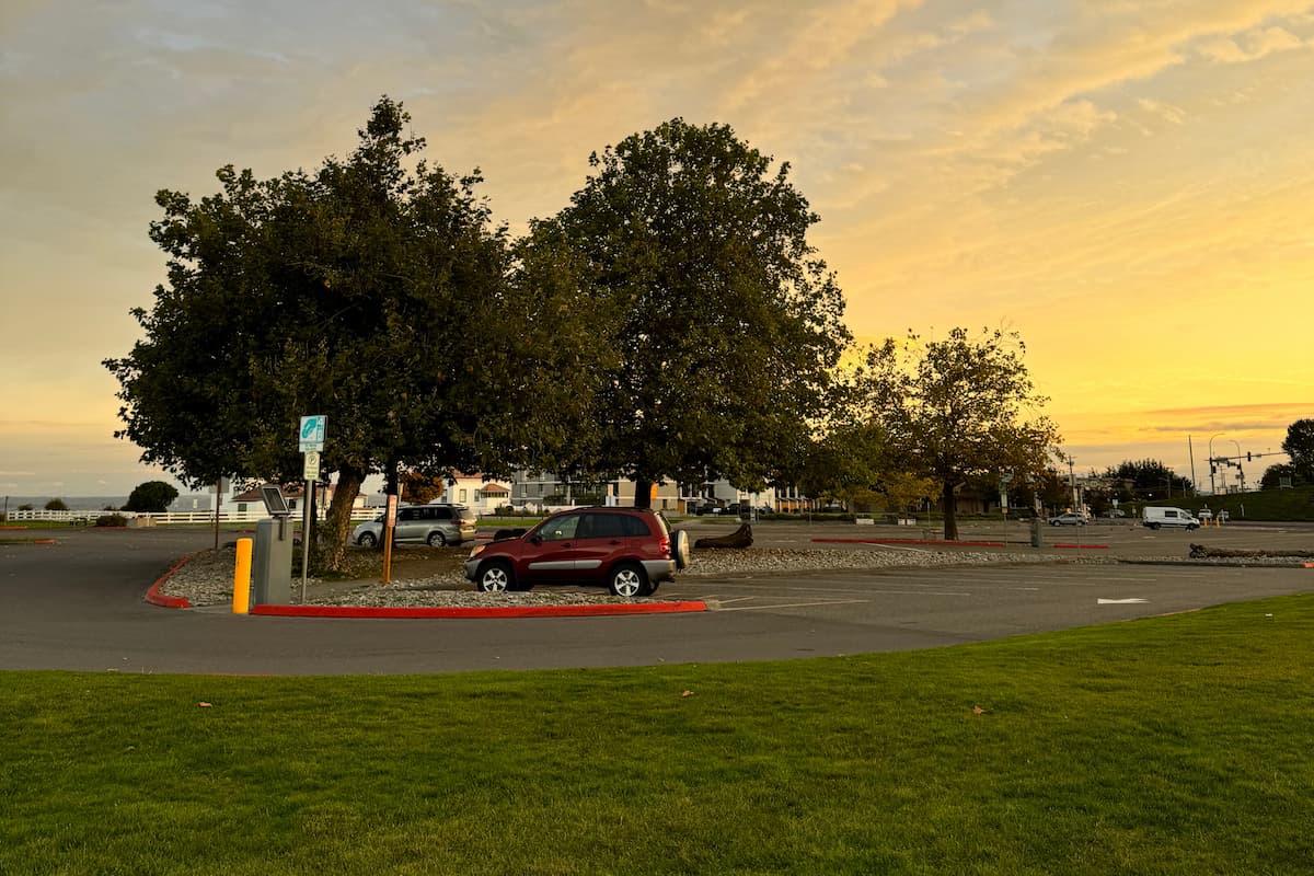 Bus drop off area in main parking lot to the right of the bathrooms when you are facing the beach.